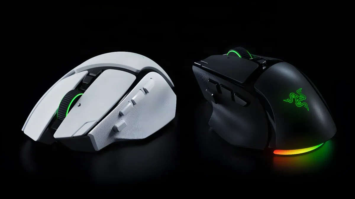Two Razer Basilisk V4 gaming mice, one white and one black, with glowing green accents and RGB lighting on a dark reflective surface.