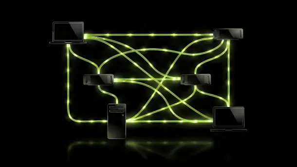 Glowing green network links connect laptops and devices in a distributed system on a dark reflective surface.