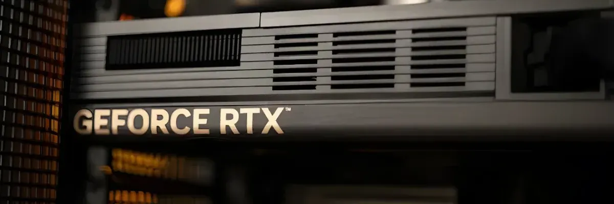 Close-up of a silver GeForce RTX graphics card with ventilation grilles, installed in a computer case.