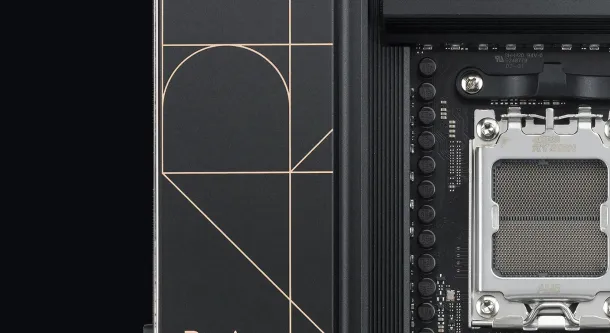 Black ASUS ProArt motherboard with gold accents, CPU socket, RAM slots, and M.2 slots, featuring geometric design elements.