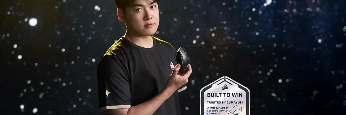 A man in a black t-shirt holds a gaming mouse against a starry background, next to a "Built to Win" badge featuring his signature.